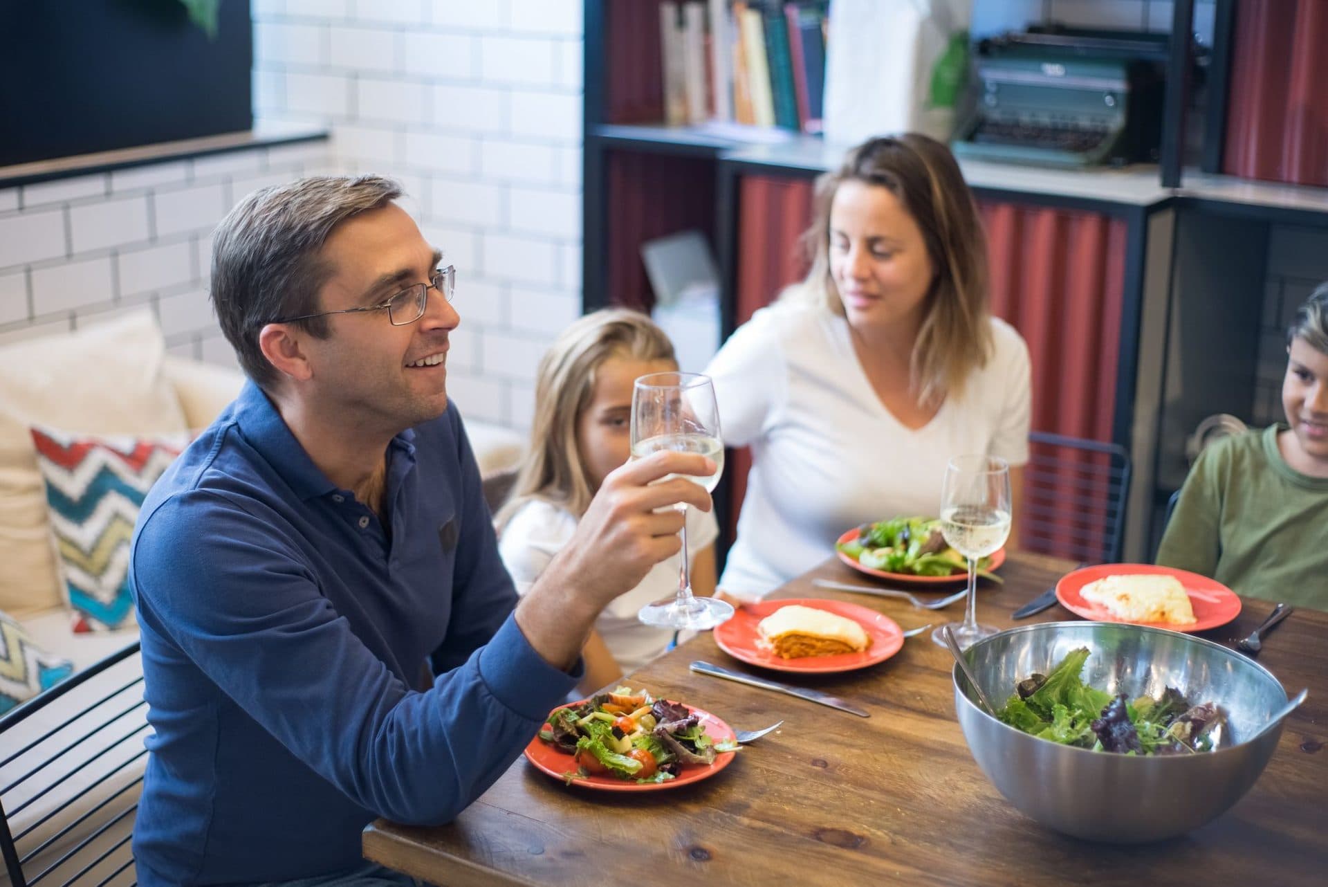 A family raising a glass at the dinner table