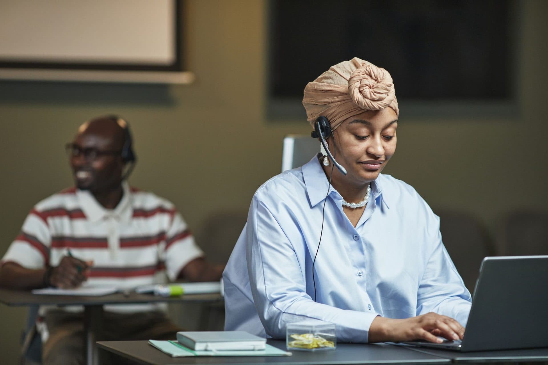 A licensed advisor in a headset working through a call at her desk